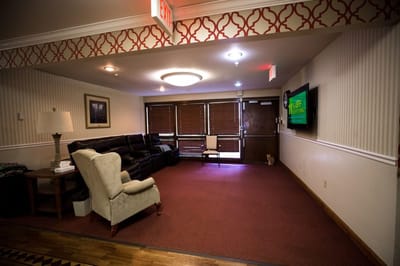 Interior common area with seating and a TV
