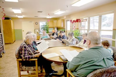 Residents engaged in a reading activity in a common area