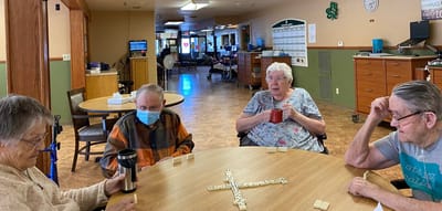 Residents enjoying a game of dominoes in a common area