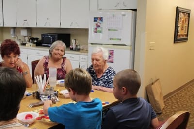 Residents engaged in a crafting activity around a table