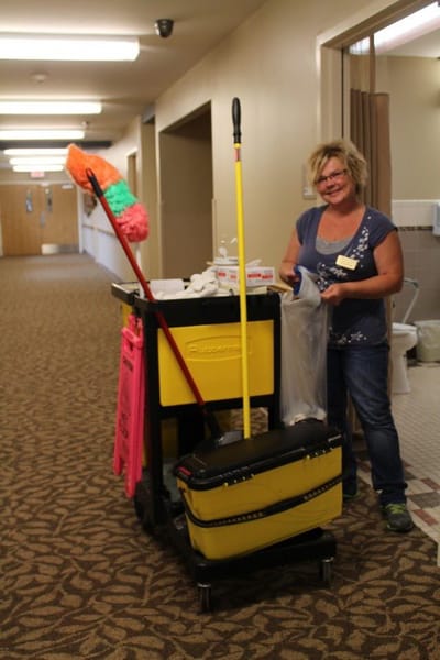 Staff member cleaning a hallway in the facility