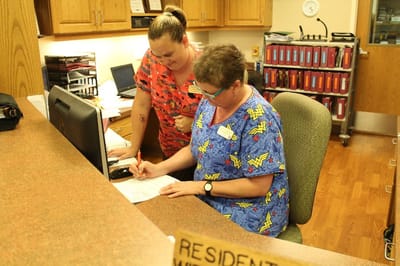 Staff assisting each other at the reception desk