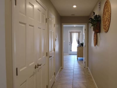 Hallway with closed doors and light coming in