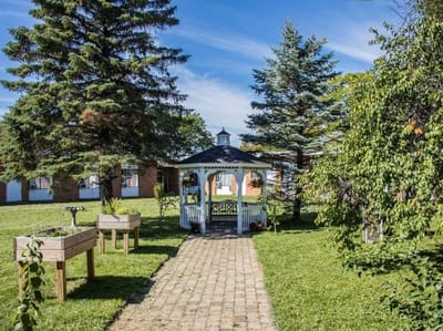 A beautiful garden area with a gazebo and pathways