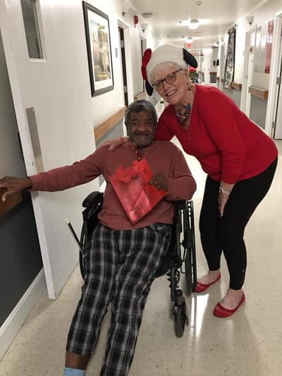 Resident and staff member celebrating in the hallway
