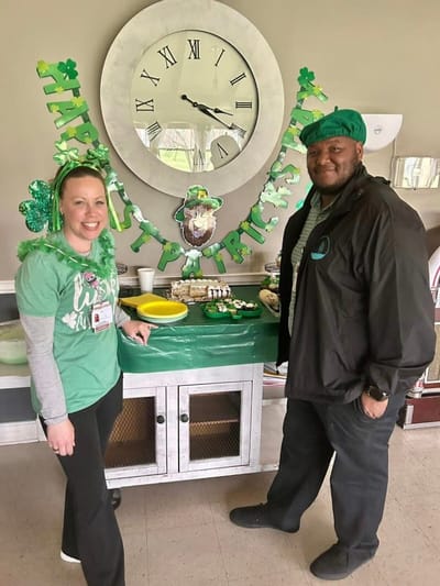 Staff celebrating St. Patrick's Day with food and decorations