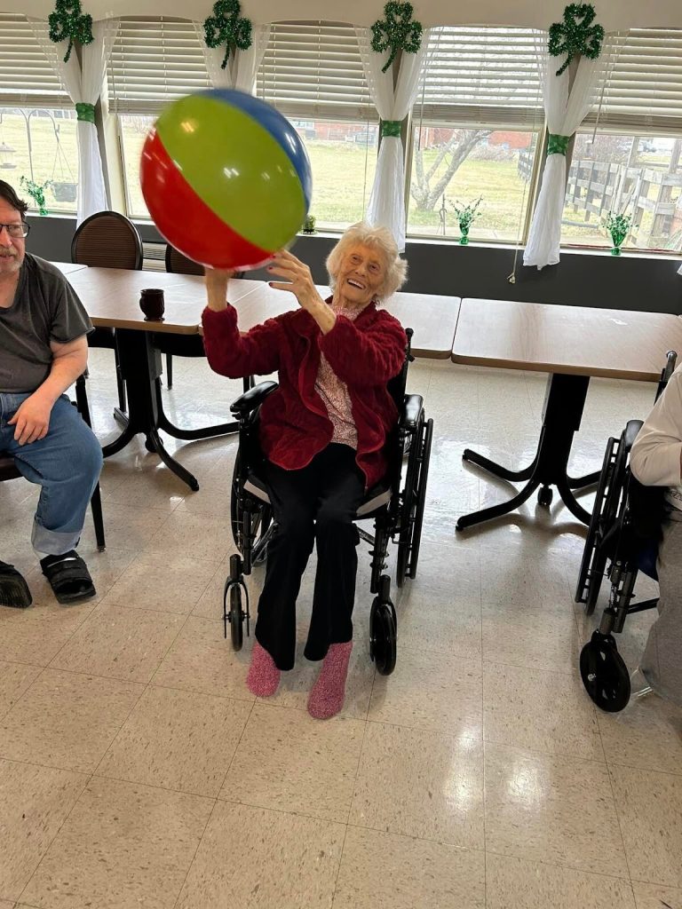Resident playing with a beach ball in the common area
