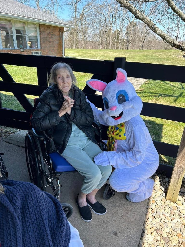 A resident with a costumed bunny character outside