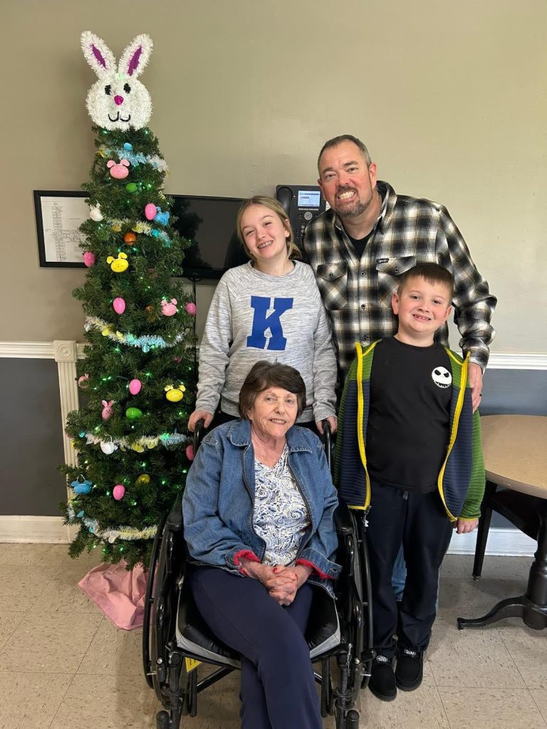 Family visit with residents around a decorated tree