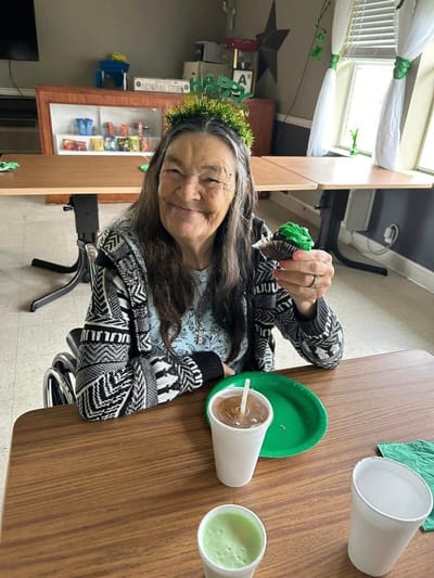 Resident enjoying a cupcake during a celebration