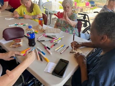 Residents engaging in a creative activity with markers