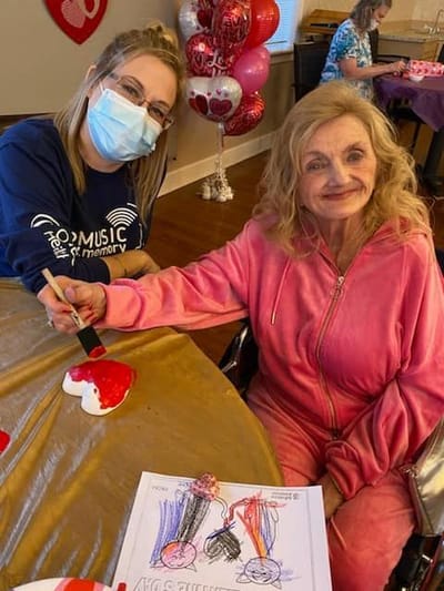 Residents engaging in a creative activity with staff