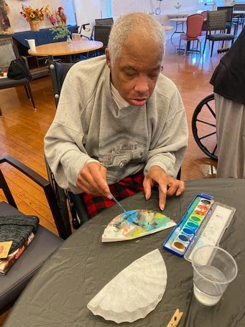 Resident painting during an art activity session