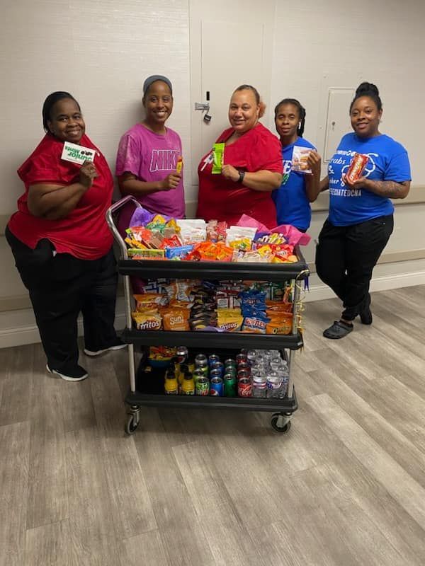 Staff members with a snack cart in a facility