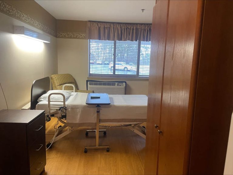 Private resident room with a hospital bed and window