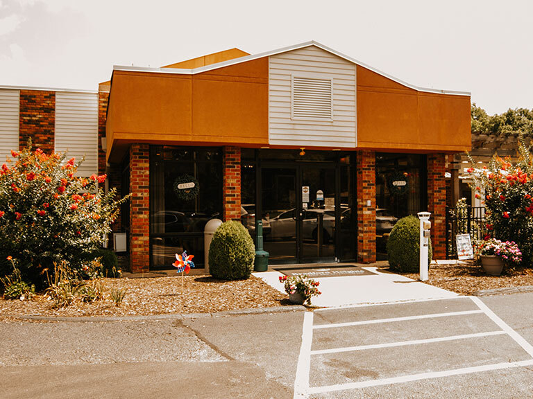 Exterior view of a senior living facility with landscaping