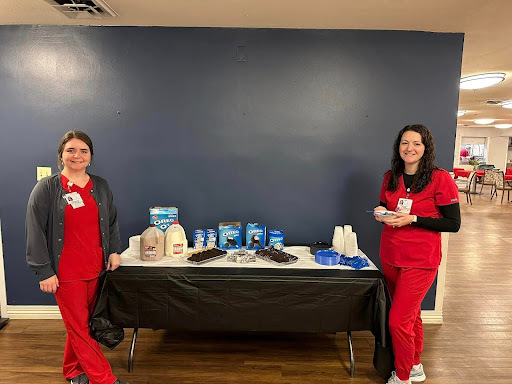 Staff serving desserts at a social event
