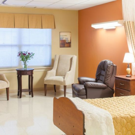 Cozy resident room with chairs and a bed