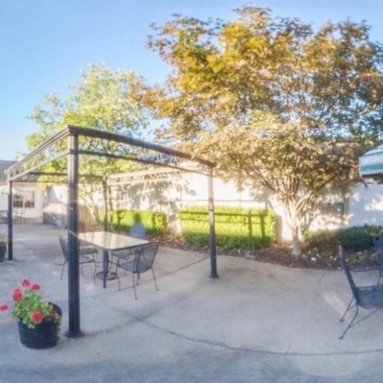 Outdoor patio area with seating and flowers