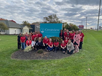 Staff gathered outside the Crestview facility sign