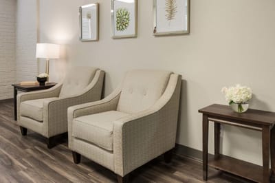 Cozy seating area with two chairs and decorative plants