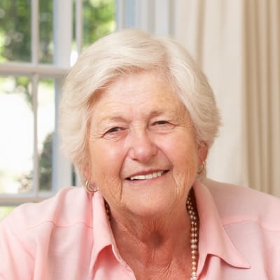 Senior woman smiling in a bright setting