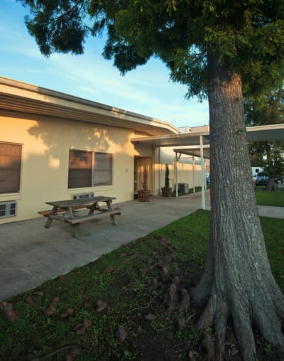 Exterior view of a senior facility with outdoor seating