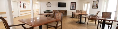 Bright dining area with wooden tables and chairs