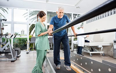 A therapist assisting a senior on a treadmill