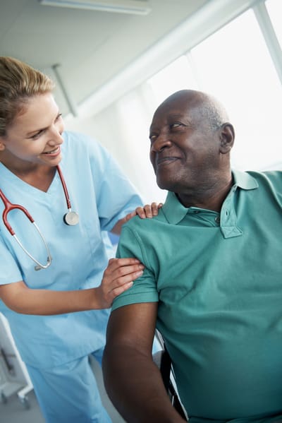 Nurse interacting with an elderly resident in a care facility