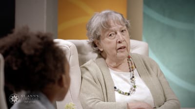 A senior resident speaking in a well-lit setting