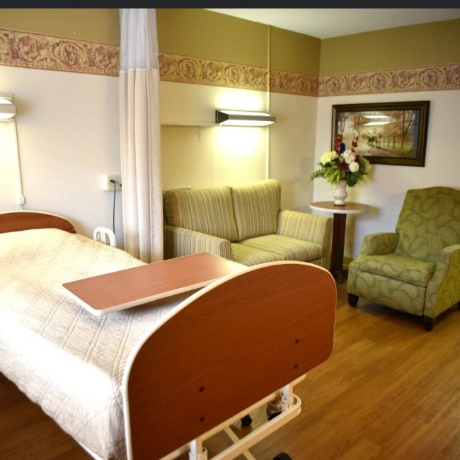 Cozy resident room with seating and flowers
