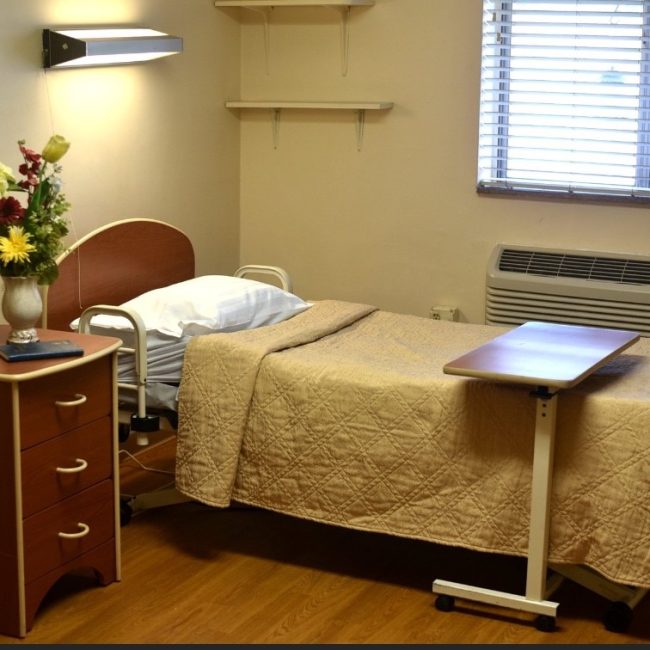 Cozy private room with bed and bedside table