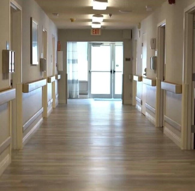 Well-lit corridor in a senior living facility
