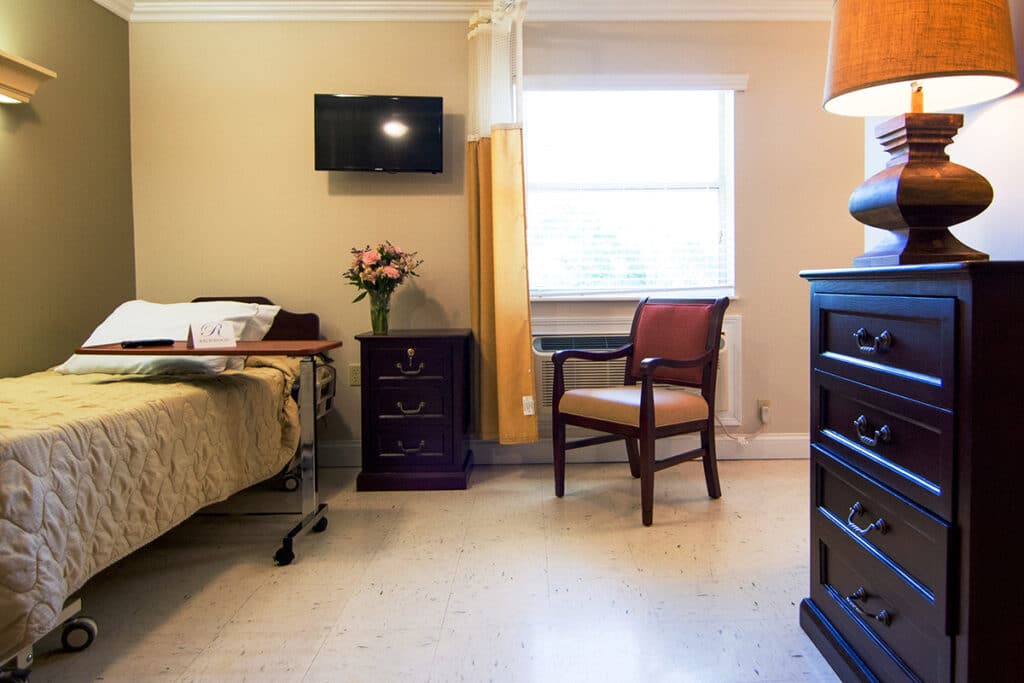 Cozy resident room with bed and chair