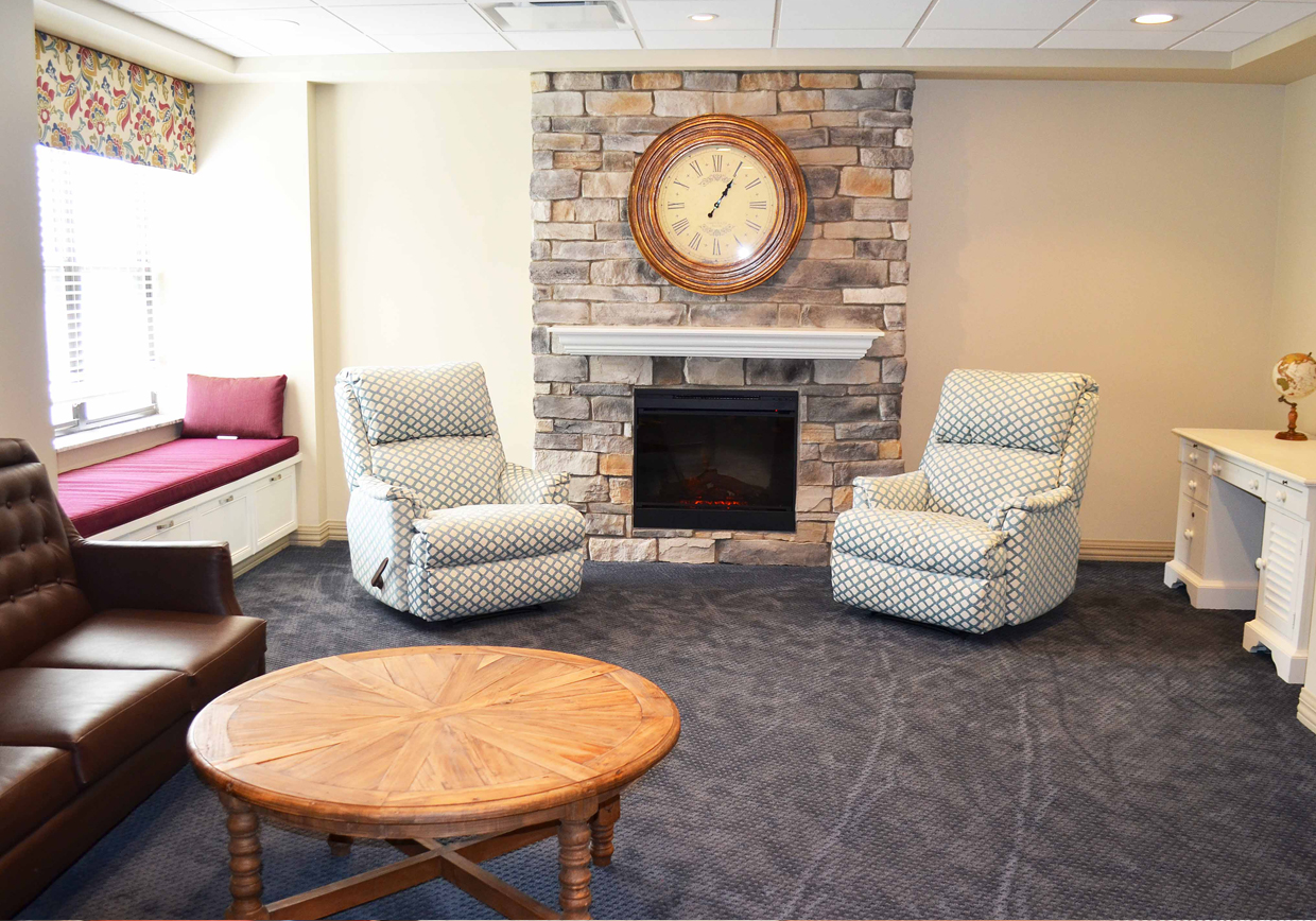 Cozy common area with chairs and a fireplace