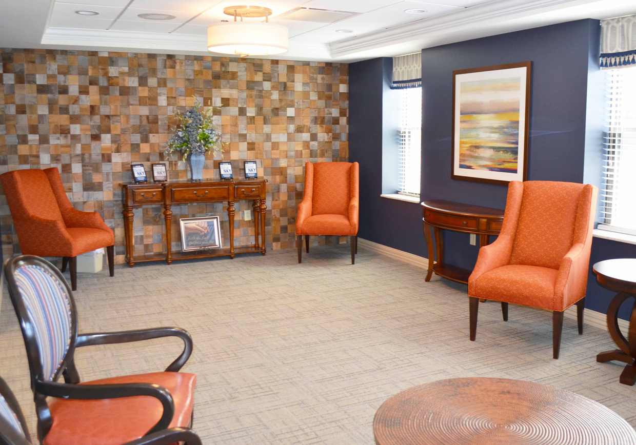 Cozy common area with orange chairs and decorative wall