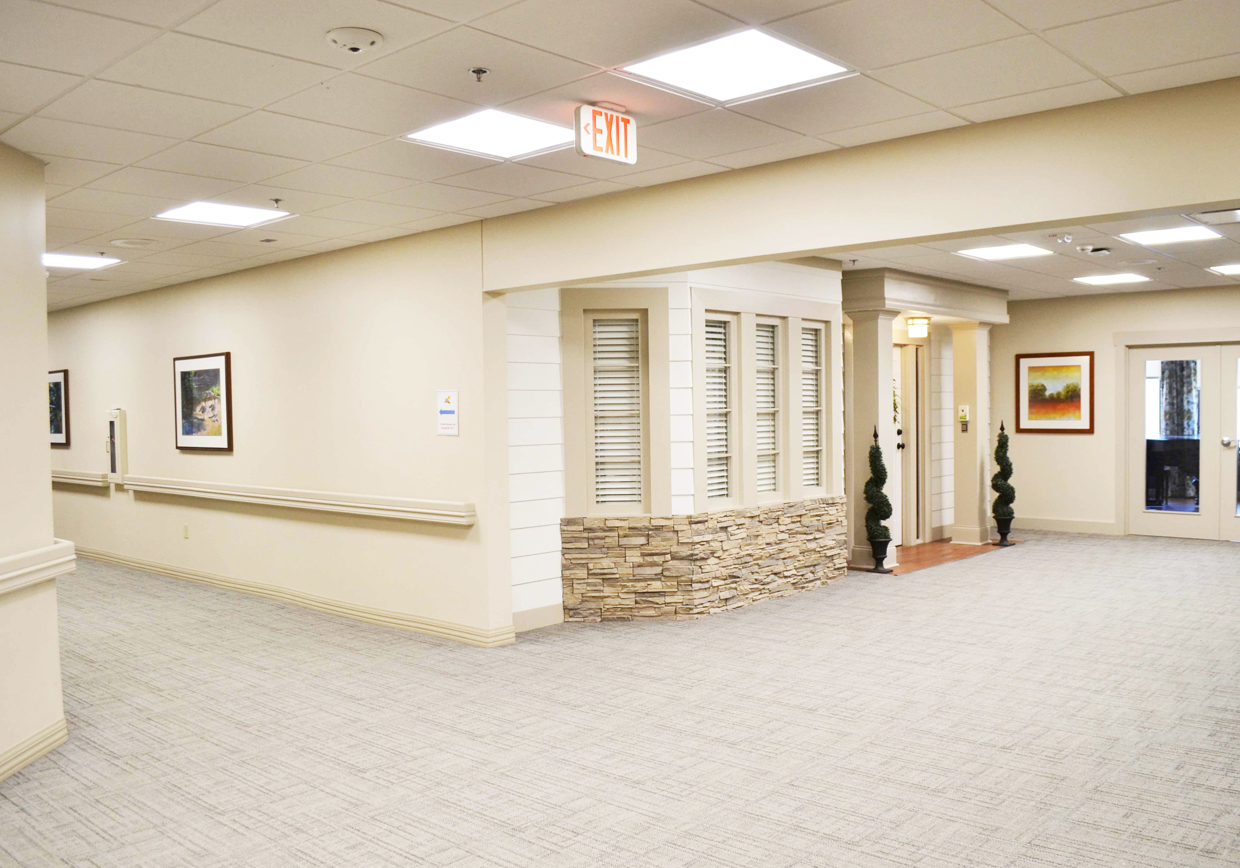 Well-lit interior hallway in a senior living facility