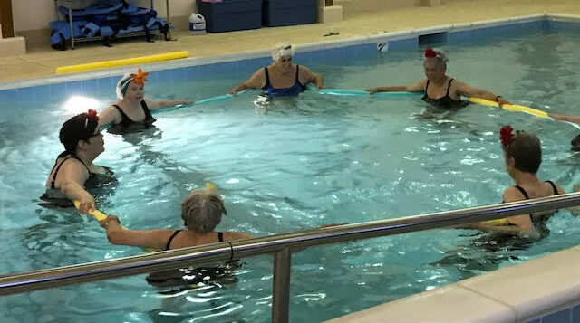 Residents participating in water aerobics class