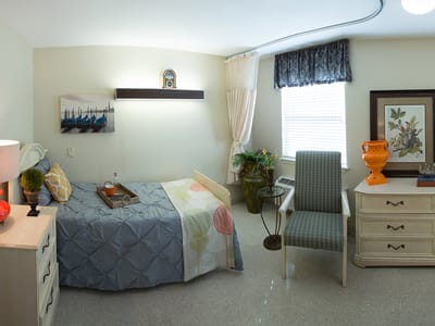 Cozy private resident room with bed and furniture