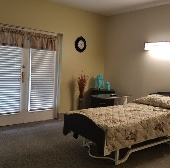 A cozy resident room with a bed and natural light