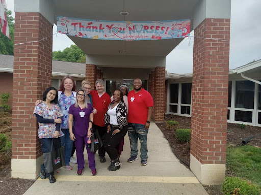 Team of staff members in front of a facility entrance