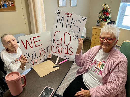 Residents participating in a sign-making activity
