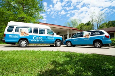Facility transport vehicles parked in front of the building