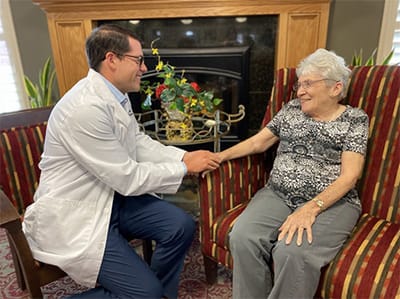 Staff member engaging with a resident in a cozy living area