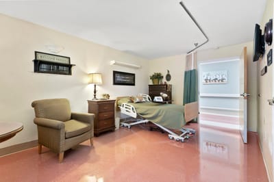 Private resident room with a bed and seating area