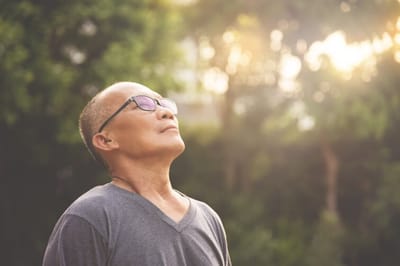 Senior man enjoying the outdoors with sunlight
