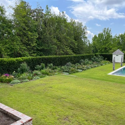 Well-maintained garden area with pool and greenery