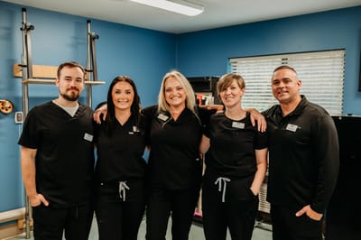 Staff members posing together in a facility