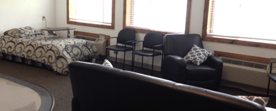 Cozy interior of a resident room with a bed and seating